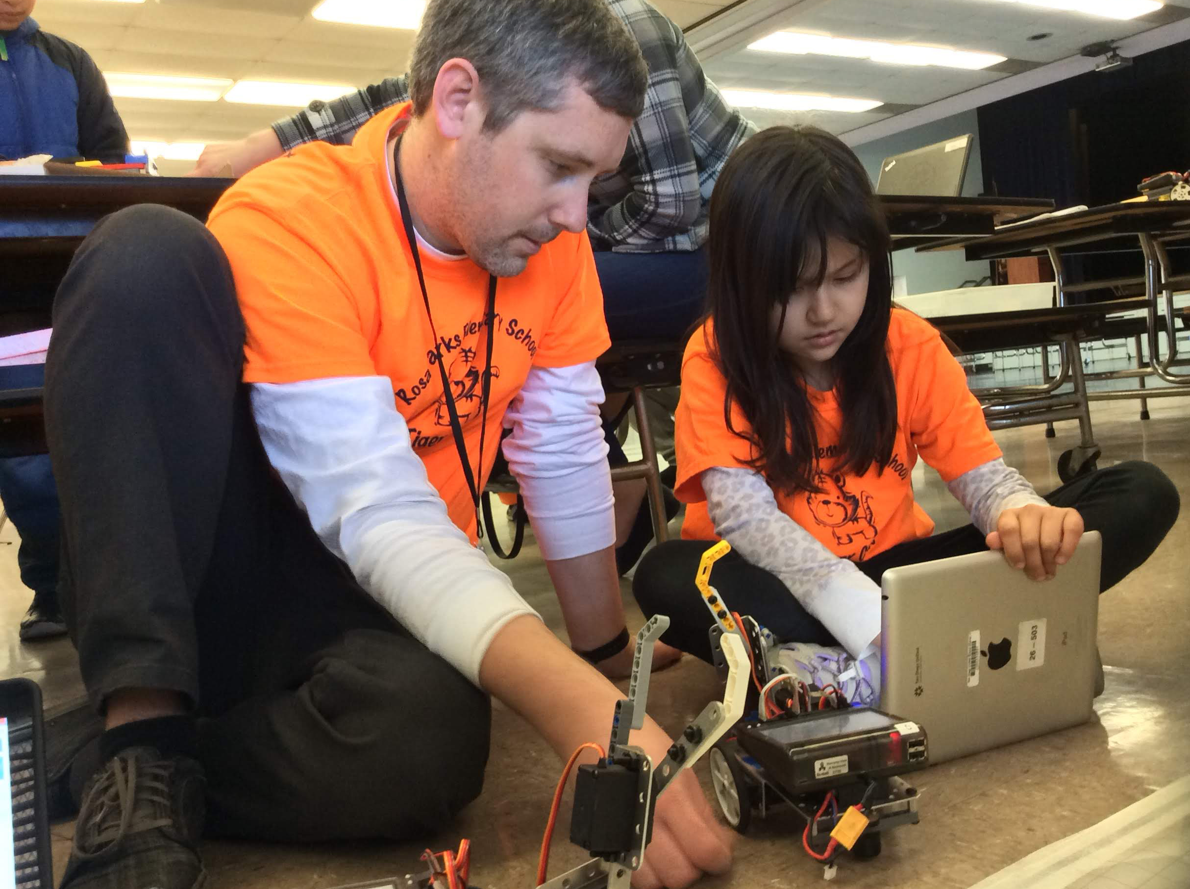 Robotics Club students programing an educational robot.