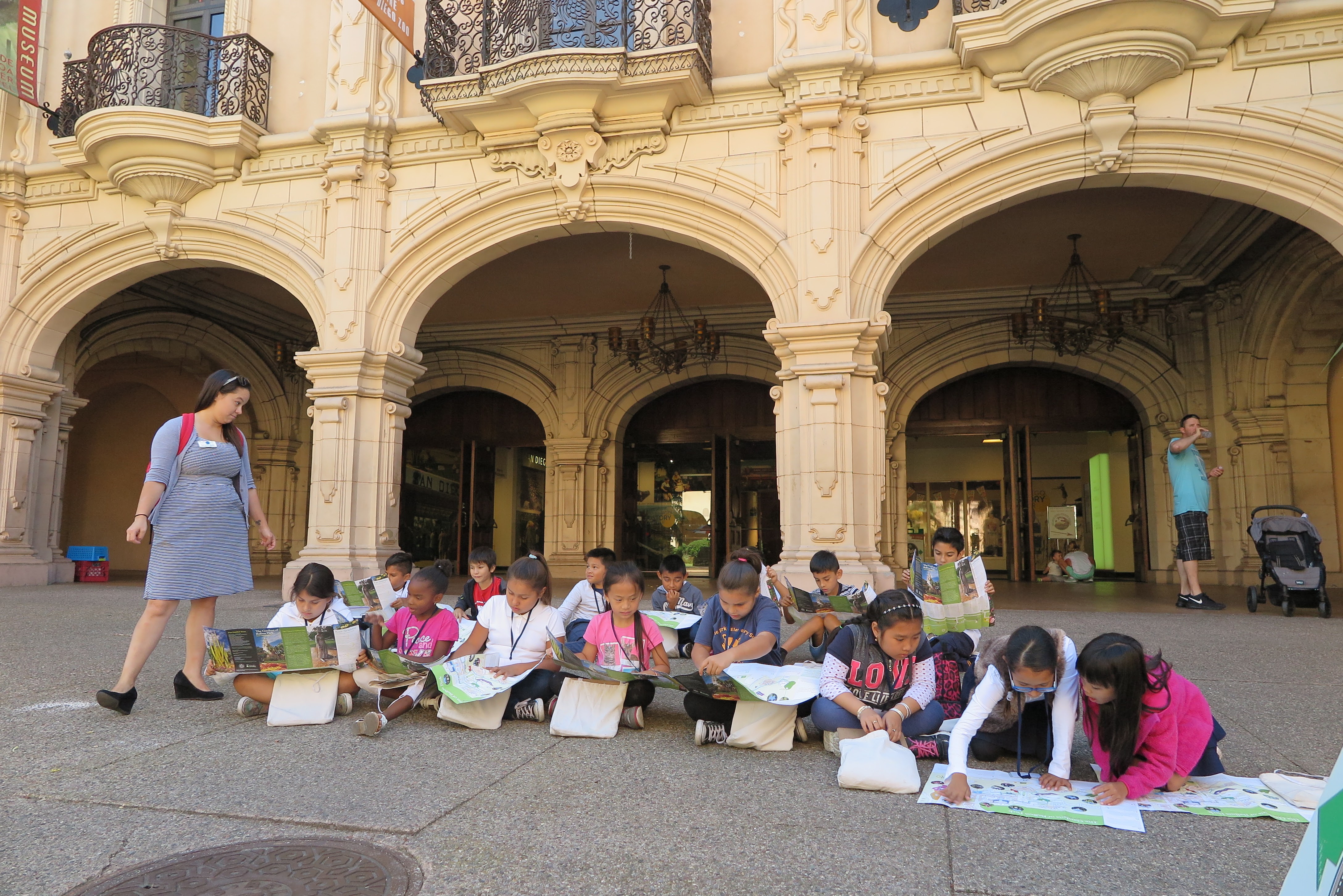 History center Students exploring with maps.